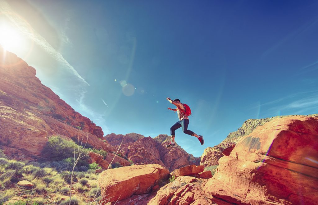 Athletic Man Jumping Between Rocks In Outdoor National Park (1)